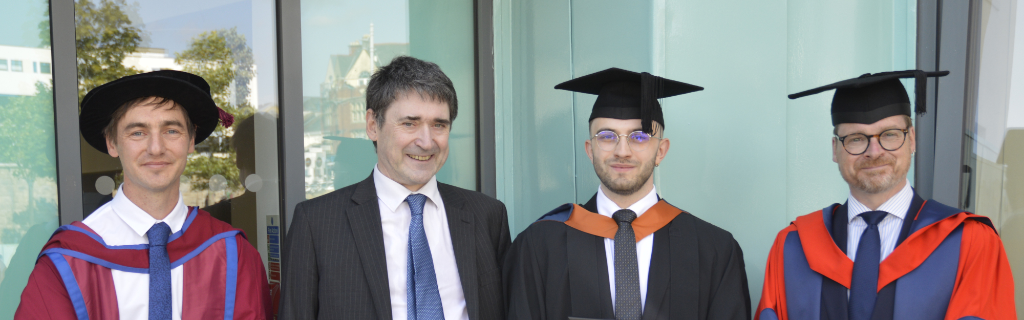 Alexander Trzcinski-Draper with Dr Rory Hopcroft (left), Alastair Revell (second left) and Professor Alexander Belton (right).
