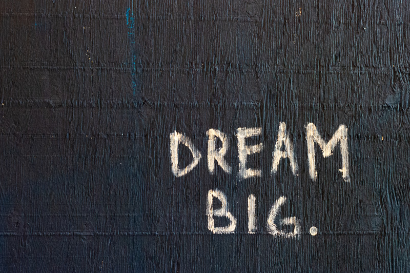 The words 'Dream Big' painted on a black background.